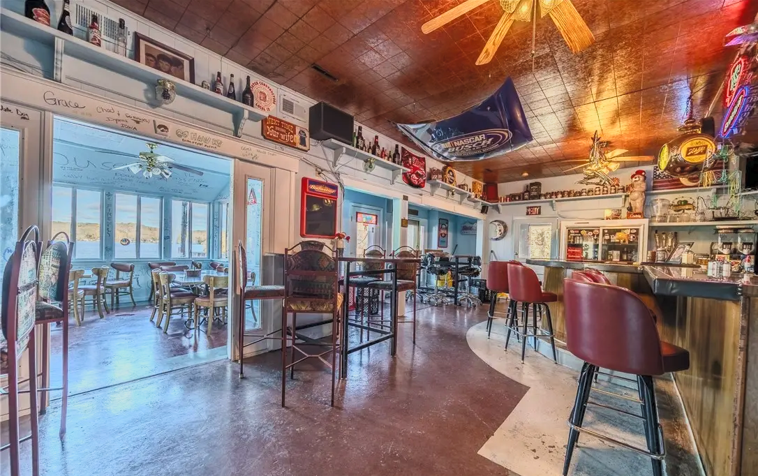 Inside Moonies, looking past the bar toward the lakeside dining porch and the water beyond
